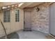 Condo front entrance with stone wall accent and covered entry at 3235 E Camelback Rd # 124, Phoenix, AZ 85018