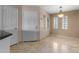 Hallway leading to dining area with updated travertine floors at 3235 E Camelback Rd # 124, Phoenix, AZ 85018