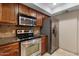 Updated kitchen features stainless steel appliances and granite countertops at 3235 E Camelback Rd # 124, Phoenix, AZ 85018