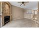 Spacious living room featuring tile floors, fireplace, and view of dining area at 3235 E Camelback Rd # 124, Phoenix, AZ 85018