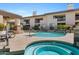 Community pool and spa area with lounge chairs and lush landscaping for relaxation at 3235 E Camelback Rd # 124, Phoenix, AZ 85018
