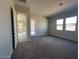 A spacious bedroom featuring carpet, multiple windows and doors leading to other rooms at 3248 W San Cristobal Rd, San Tan Valley, AZ 85144