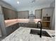 Close up of kitchen showcasing countertops, cabinets, stainless steel range hood, and black kitchen faucet at 3248 W San Cristobal Rd, San Tan Valley, AZ 85144