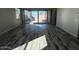 Bright, airy living room features wood-look tile floors and a sliding glass door to the backyard at 3248 W San Cristobal Rd, San Tan Valley, AZ 85144