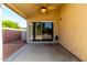 Covered back patio features a ceiling fan and view of the backyard with desert landscaping at 4214 W Marco Polo Rd, Glendale, AZ 85308
