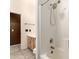 Bathroom with tub and shower combo with white tiling at 4214 W Marco Polo Rd, Glendale, AZ 85308
