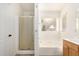 Bright bathroom features a glass shower, separate tub, and a window for natural light at 4214 W Marco Polo Rd, Glendale, AZ 85308