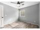 Bedroom with hardwood flooring, ceiling fan, and natural light from window at 4214 W Marco Polo Rd, Glendale, AZ 85308