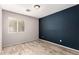 Bedroom featuring hardwood flooring, a window, and a contrasting accent wall at 4214 W Marco Polo Rd, Glendale, AZ 85308
