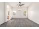 Spacious bedroom with carpet floors, a ceiling fan, and access to the en-suite bathroom at 4214 W Marco Polo Rd, Glendale, AZ 85308