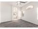 Bright and airy bedroom features neutral paint, carpet floors, and archway to ensuite bathroom at 4214 W Marco Polo Rd, Glendale, AZ 85308