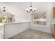 Bright dining area featuring tile floors, a modern chandelier, and a window with natural light at 4214 W Marco Polo Rd, Glendale, AZ 85308
