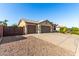 Charming home with a three-car garage, tile roof, neutral colors, and minimal landscaping at 4214 W Marco Polo Rd, Glendale, AZ 85308