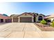 Charming home with a three car garage, tile roof, neutral colors, and desert landscaping at 4214 W Marco Polo Rd, Glendale, AZ 85308