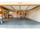Spacious garage featuring built-in shelving, work bench, concrete flooring and overhead lighting at 4214 W Marco Polo Rd, Glendale, AZ 85308