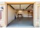 Clean garage features concrete flooring, work bench, shelving, and overhead lighting at 4214 W Marco Polo Rd, Glendale, AZ 85308