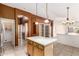 Bright kitchen island with stainless steel appliances, wood cabinets and lots of room for storage at 4214 W Marco Polo Rd, Glendale, AZ 85308