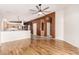 Open concept living room showcases wood floors, neutral tones, and archway to kitchen at 4214 W Marco Polo Rd, Glendale, AZ 85308