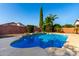 Backyard pool with patio space, palms, bushes, and a block wall at 4214 W Marco Polo Rd, Glendale, AZ 85308