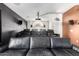 Basement theater room with tiered seating, projector screen, and surround sound speakers at 4214 W Marco Polo Rd, Glendale, AZ 85308