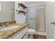 Bathroom featuring a shower, wood shelves and granite countertop at 4346 W Mescal St, Glendale, AZ 85304