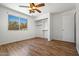 Spacious bedroom with wood-look floors, a window, and a closet at 4346 W Mescal St, Glendale, AZ 85304