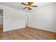 Bedroom featuring wood-look floors, a ceiling fan, and neutral colored walls at 4346 W Mescal St, Glendale, AZ 85304