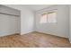 Bedroom featuring wood-look floors, a window with blinds, and a closet at 4346 W Mescal St, Glendale, AZ 85304
