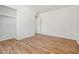 Bright bedroom with wood-look floors, a built-in closet, and neutral walls at 4346 W Mescal St, Glendale, AZ 85304
