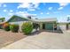 Inviting exterior view of a home with a covered driveway, charming landscaping, and a convenient storage shed at 4346 W Mescal St, Glendale, AZ 85304