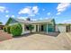 Charming single-story home featuring a covered parking area, well-maintained landscaping, and painted brick at 4346 W Mescal St, Glendale, AZ 85304