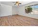 Bright living room featuring laminate flooring, neutral walls, and an inviting view through the window at 4346 W Mescal St, Glendale, AZ 85304