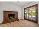Living room highlighting a brick fireplace and sliding glass doors at 4346 W Mescal St, Glendale, AZ 85304