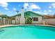 Backyard pool surrounded by concrete with blue tile trim and a white brick house with a chimney on a sunny day at 4346 W Mescal St, Glendale, AZ 85304