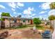 A spacious backyard with a grass, trees, and other foliage at 4438 W Hatcher Rd, Glendale, AZ 85302