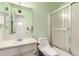 A bathroom featuring a shower, toilet, and vanity with sink at 4438 W Hatcher Rd, Glendale, AZ 85302
