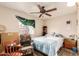A bedroom featuring a ceiling fan, window, and assorted furniture at 4438 W Hatcher Rd, Glendale, AZ 85302
