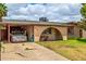 Cozy home featuring a covered carport, arched entryway, and well-kept lawn at 4438 W Hatcher Rd, Glendale, AZ 85302