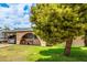 Cozy home featuring a covered carport, arched entryway, and well-kept lawn at 4438 W Hatcher Rd, Glendale, AZ 85302