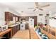 A kitchen featuring wood cabinets, white appliances, and ceiling fan at 4438 W Hatcher Rd, Glendale, AZ 85302