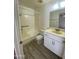 Well-lit bathroom with modern vanity, tile floor, and tub with shower at 4820 N 89Th Ave # 88, Phoenix, AZ 85037