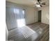 Bright bedroom features hard surface floors, neutral paint, a ceiling fan, and sliding glass door providing natural light at 4820 N 89Th Ave # 88, Phoenix, AZ 85037
