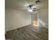 Large bedroom with hard surface floors, ceiling fan, and a sliding glass door leading to outdoor spaces at 4820 N 89Th Ave # 88, Phoenix, AZ 85037