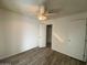 Bright bedroom features a ceiling fan, closet, and neutral decor at 4820 N 89Th Ave # 88, Phoenix, AZ 85037