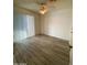 This bright bedroom with a ceiling fan has a large window with blinds at 4820 N 89Th Ave # 88, Phoenix, AZ 85037