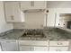 Kitchen with white cabinetry, granite countertops, modern sink, and stainless steel dishwasher for easy cleanup at 4820 N 89Th Ave # 88, Phoenix, AZ 85037