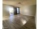 Open-concept living room with neutral paint, hard surface floors, and bright natural light from the exterior entrance at 4820 N 89Th Ave # 88, Phoenix, AZ 85037