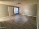 Inviting living room with plenty of space, neutral paint, hard surface floors, and bright natural light from the window at 4820 N 89Th Ave # 88, Phoenix, AZ 85037