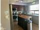 Kitchen with stainless steel appliances, center island with wood counter top, and dark cabinets at 491 E Jeanne Ln, San Tan Valley, AZ 85140