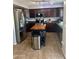 Kitchen featuring stainless steel appliances, dark cabinets, tile flooring, and a center island at 491 E Jeanne Ln, San Tan Valley, AZ 85140